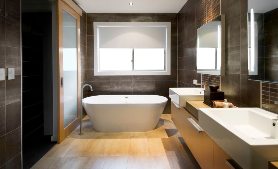 Modern bathroom with freestanding tub and double sinks.