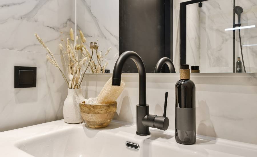 Modern bathroom interior with black faucet and decor.