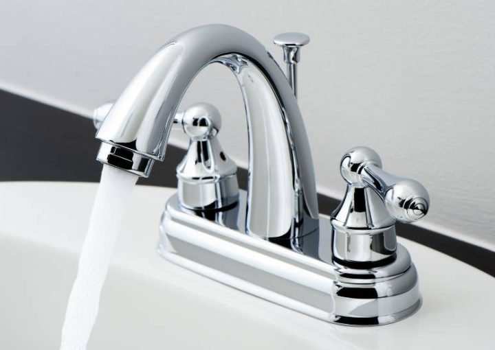 Chrome bathroom faucet with running water