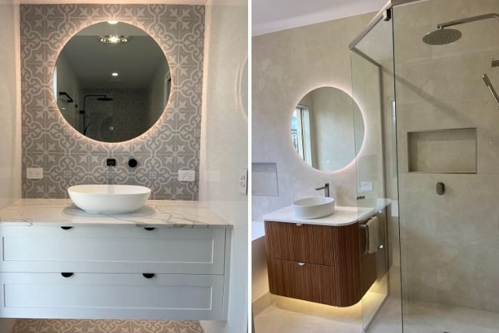 Modern bathroom with round mirrors and glass shower.