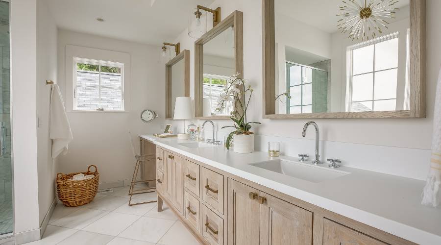 Modern bathroom with double vanity sinks and mirrors.