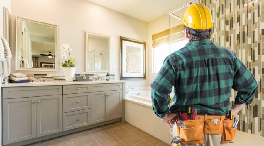 Contractor assessing modern bathroom renovation project.