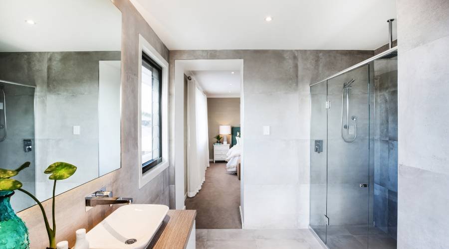 Modern bathroom with shower and bedroom view