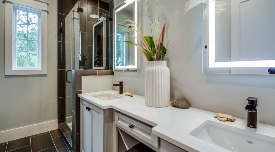 Modern bathroom with double sink and large mirror.