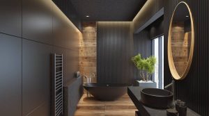 Modern bathroom with dark decor and round mirror.