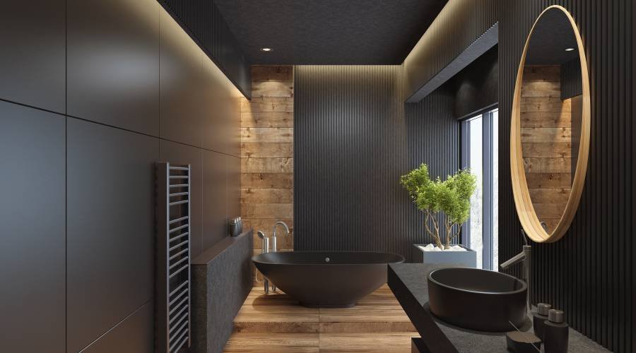 Modern bathroom with dark decor and round mirror.