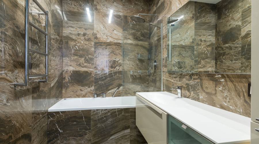 Luxury marble bathroom with bathtub and sink.