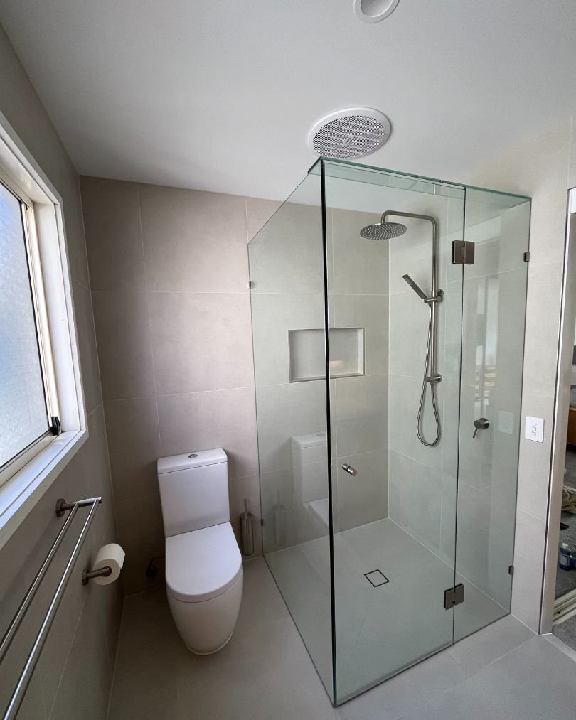 Modern bathroom with glass shower and toilet