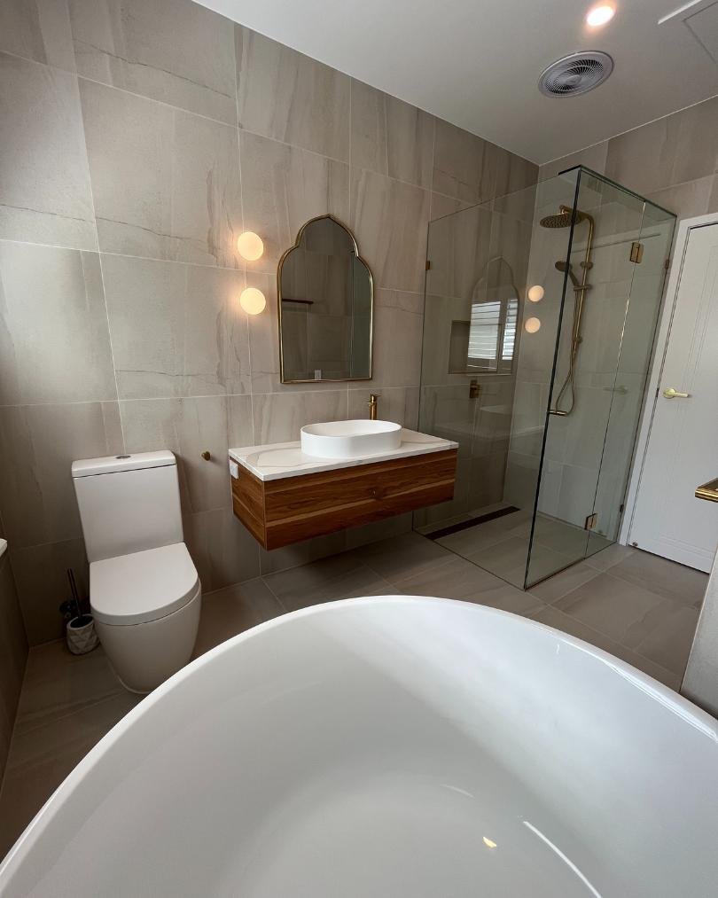 Modern bathroom with tub, sink, and glass shower.
