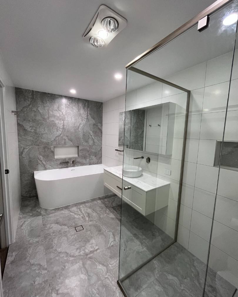Modern bathroom with bathtub and glass shower