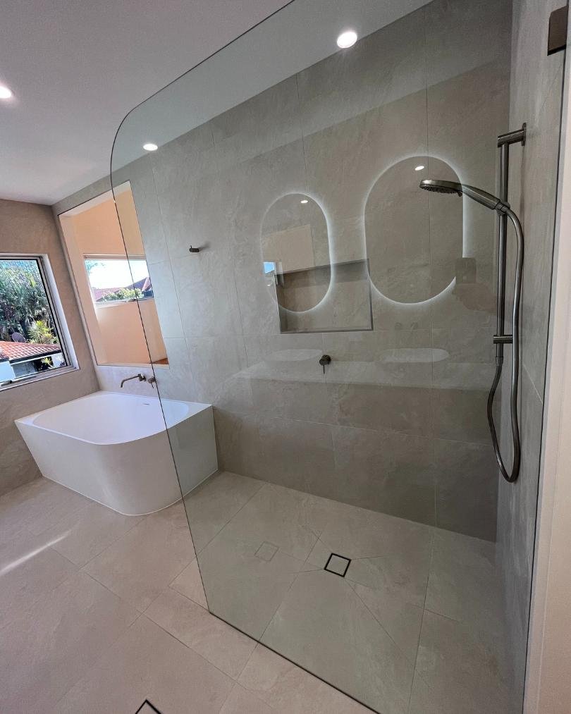 Modern bathroom with bathtub and glass shower.