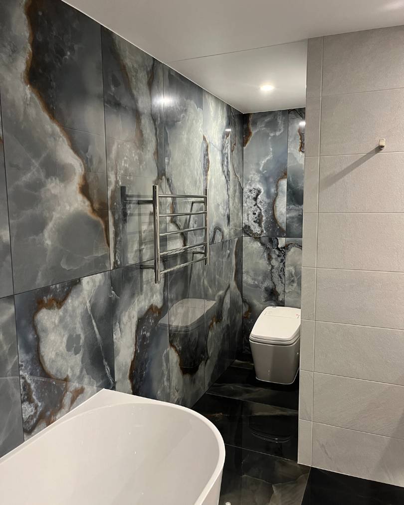 Modern bathroom with marble walls and bathtub